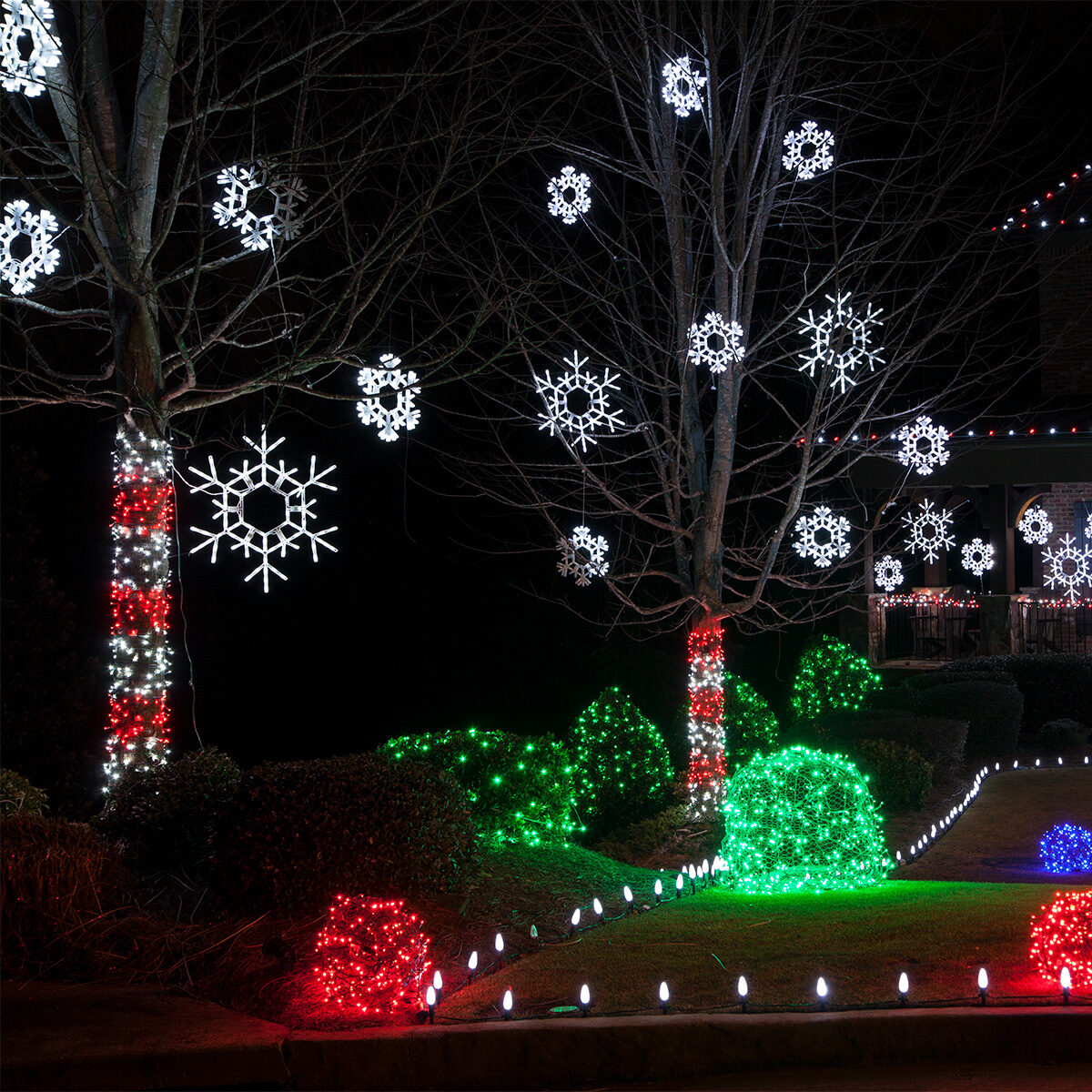 Folding Christmas Snowflakes Hanging From Tree Branches