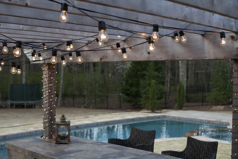 Deck Lighting Ideas with Brilliant Results! - Yard Envy - Hang patio lights on the deck and by the pool to create an inviting and  inspirational