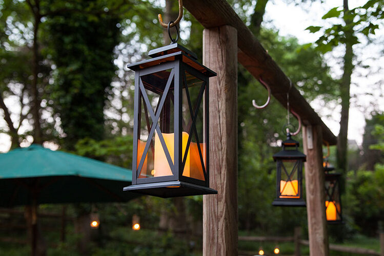 Hang candle lanterns from S hooks to illuminate the backyard quickly!