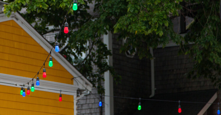 Hanging colorful patio lights in the backyard makes everything brighter!