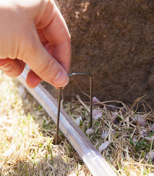 Use Garden Staples to Secure Rope Light in Soft Ground